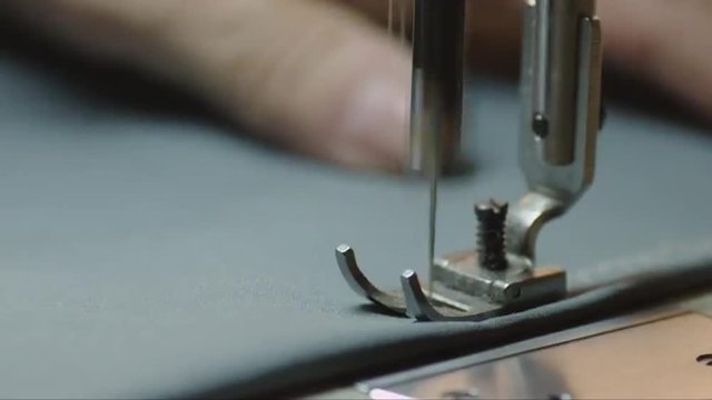 Close-up shot of a sewing machine needle in action. Shot on RED Cinema Camera.