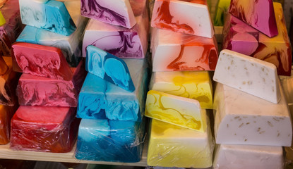 Fancy colored hand made blocks of soap. Street market.
