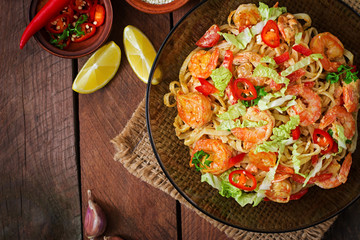 Udon pasta with shrimp, tomatoes and paprika. Top view