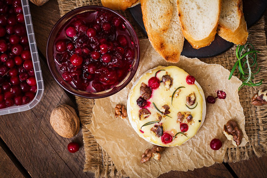 Baked cheese Camembert with cranberries and nuts. Top view