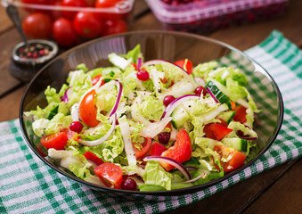 Dietary salad with fresh vegetables (tomato, cucumber, Chinese cabbage, red onion and cranberries)