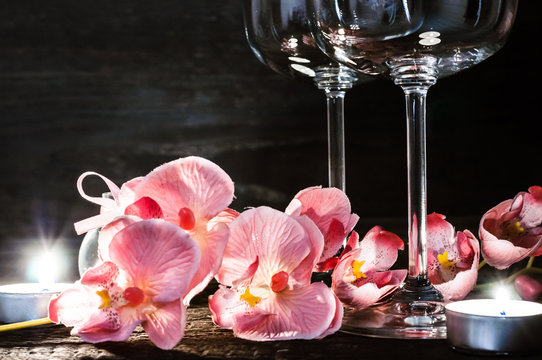 wine glasses orchids and candles for a romantic evening