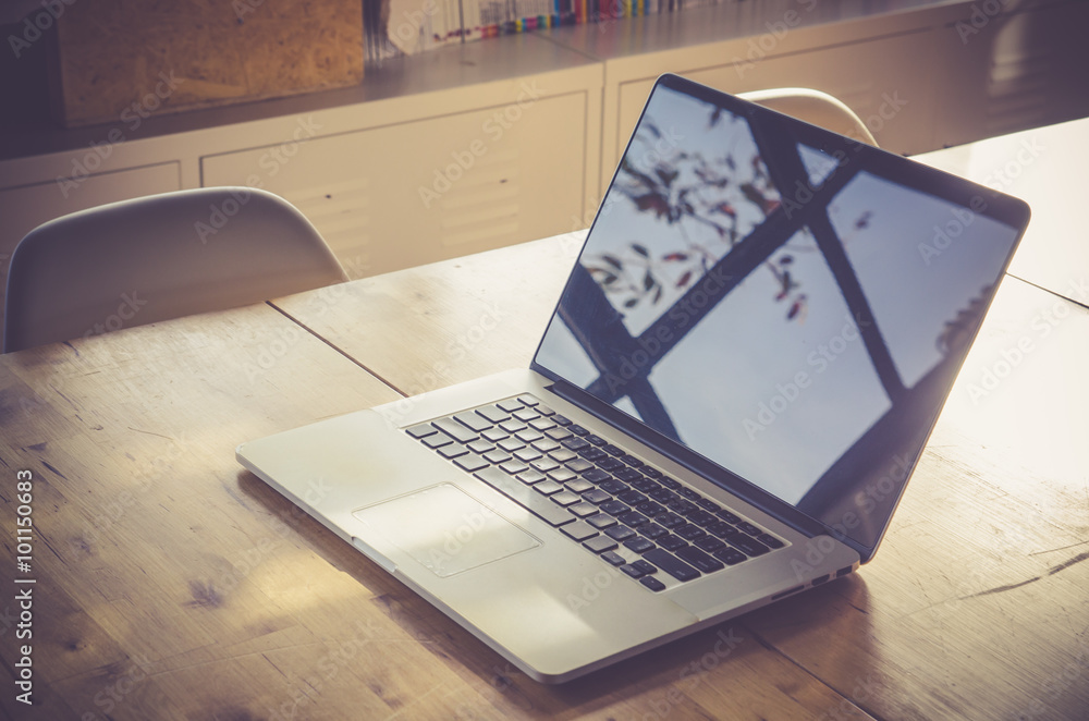 Wall mural workspace with modern laptop on wood table