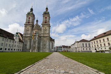 Fototapeta na wymiar St. Gallen Cathedral / St. Gallen, Switzerland - April 23, 2012: The Cathedral of Saint Gallen in Switzerland. A wide angle view showing the gardens and the abbeys in a sunny springtime day.