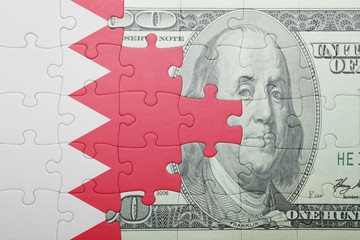 puzzle with the national flag of bahrain and dollar banknote