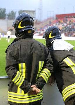 two firefighters with hardhat during the sports event