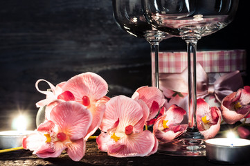 wine glasses orchids and candles for a romantic evening