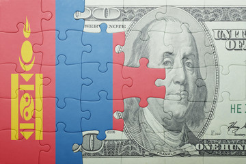 puzzle with the national flag of mongolia and dollar banknote