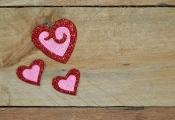 Sparkling Red and Pink hearts set on pallet wood.  Valentine's Day, Wedding, Anniversary, romantic symbol of love.  