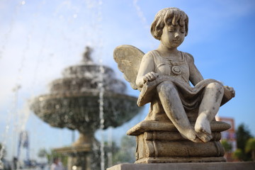 Naklejka premium Baby Angel sculpture with a fountain