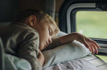 Sleeping boy in front of window