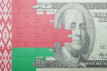 puzzle with the national flag of belarus and dollar banknote
