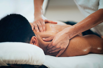 Fototapeta na wymiar Sports massage. Therapist massaging shoulders