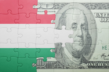 puzzle with the national flag of hungary and dollar banknote