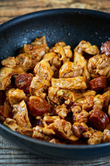 Chicken meat and chorizo cooking in the frying pan