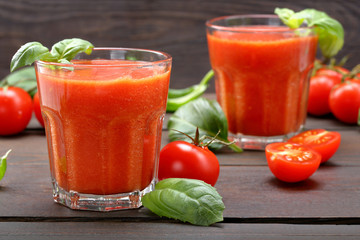 Fresh healthy tomato smoothie juice on wooden background