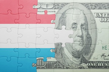 puzzle with the national flag of luxembourg and dollar banknote