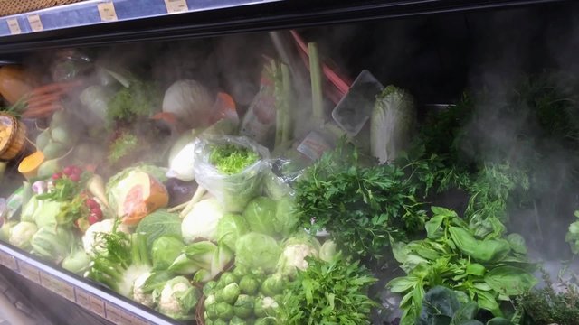 Frozen fridge with vegetables in a shop
