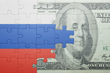 Fototapeta na wymiar puzzle with the national flag of russia and dollar banknote