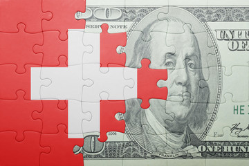 puzzle with the national flag of switzerland and dollar banknote