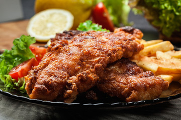 Fried fish in crispy batter with chips