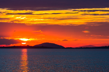 Sunset at sea, with small greek islands in background, Sithonia, Greece