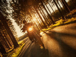 Fototapeta premium Man seat on the motorcycle on the forest road.