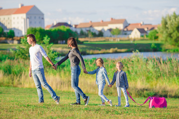 Happy family with luggage ready for traveling outdoors