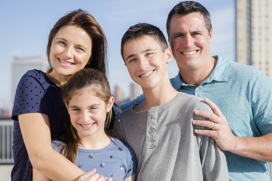 Portrait of smiling Caucasian family outdoors