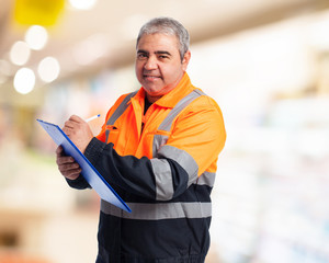 portrait of a worker writing on a paper