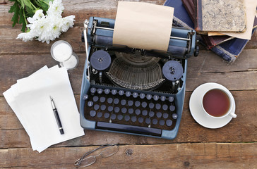 Vintage black typewriter on decorated wooden table, outdoors, close up