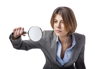 portrait of an executive young woman looking through a magnifying glass