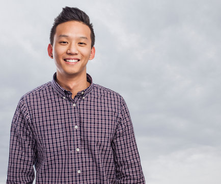 Handsome Young Asian Man Smiling Wearing A Plaid Shirt