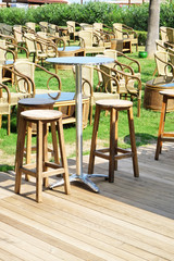 Comfortable wooden seats in cafe in Turkish park