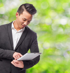 young business asian man using his tablet