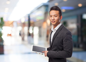 young business asian man using his tablet