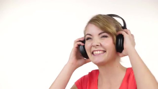 Woman in big headphones listening music dancing 4K