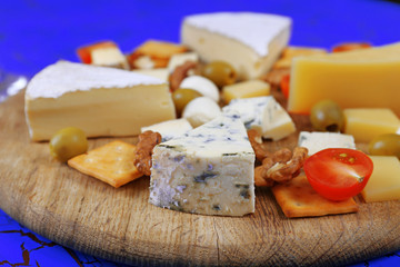 Cheese for tasting on cutting board