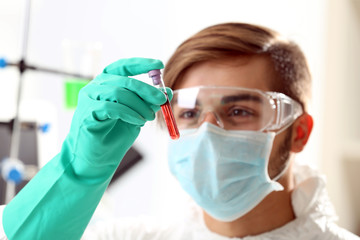 Man in laboratory checking test tubes