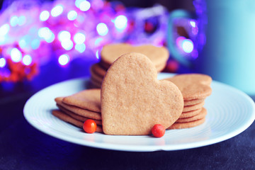 Heart shaped biscuits on plate and mug on a table