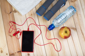 Sport Equipment. Shoes, Dumbbells And Isotonic Drink On Wooden Background.