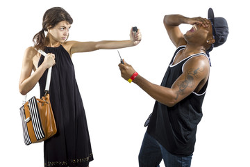 Young female refusing to be a victim of a criminal stealing her purse and holding pepperspray for...