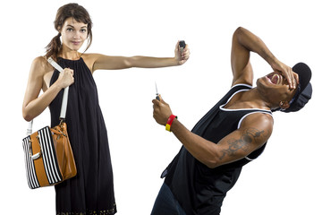 Young female refusing to be a victim of a criminal stealing her purse and holding pepperspray for...