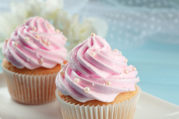 Pink cupcakes on wooden background