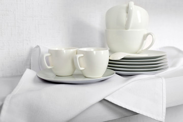 Fototapeta na wymiar Tableware with napkin on a white background, close up