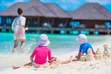 Happy family playing with beach toys on summer vacation