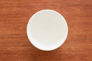 Empty bowl on a wooden board
