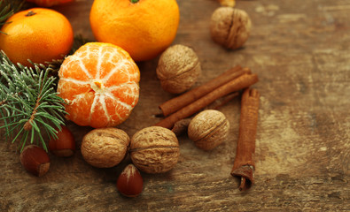 Beautiful still life with tangerines and fir-tree, on old wooden table, close up