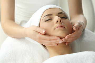 Obraz na płótnie Canvas Spa concept. Face massage. Young woman getting spa treatment, close up