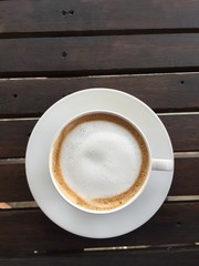 cup of coffee with milk on wood table